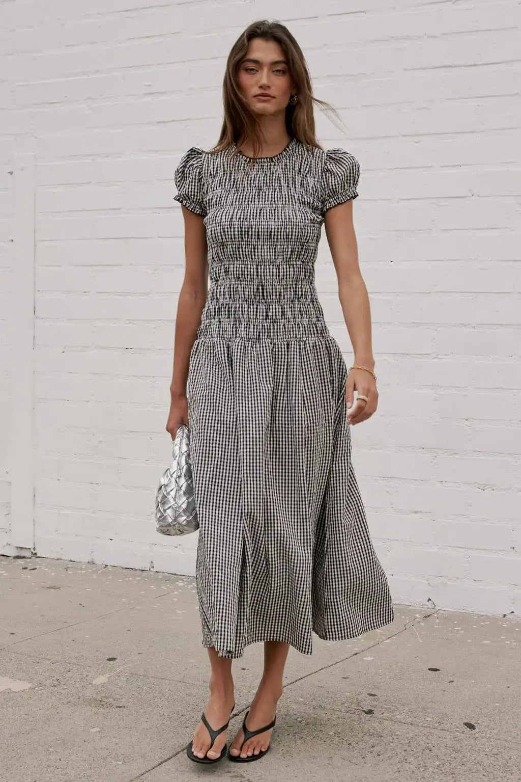 Elegant women's smocked dress with floral print from Corporación Turística, featuring a stylish, comfortable fit in a warm brown color.