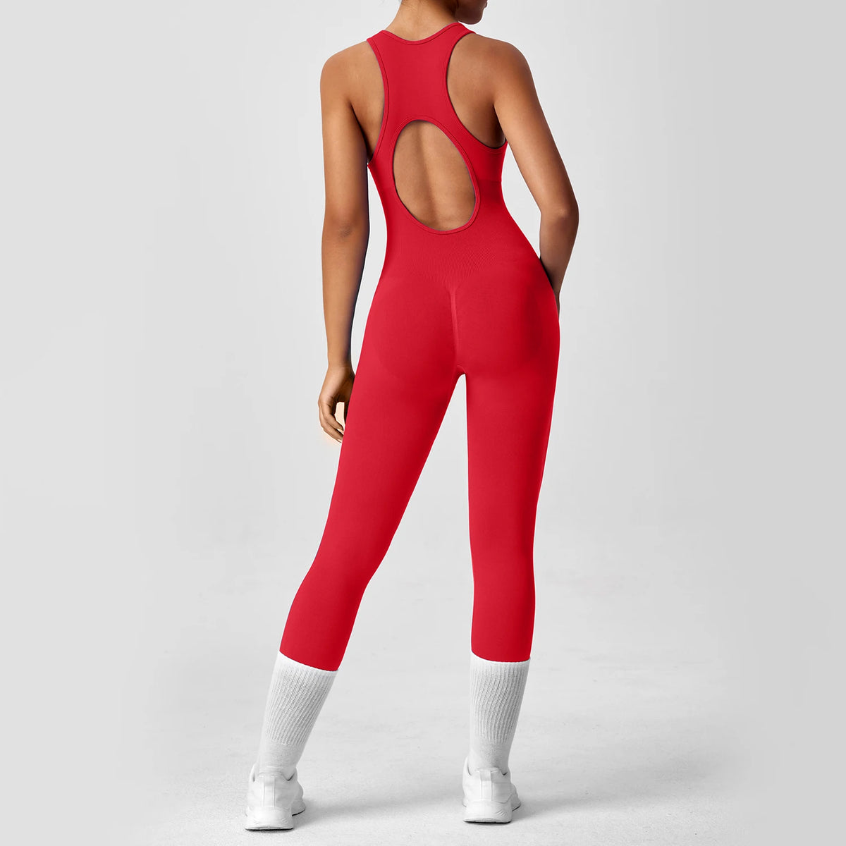Orange one-piece yoga bodysuit with matching boots, designed for comfortable movement, by Corporación Turística.
