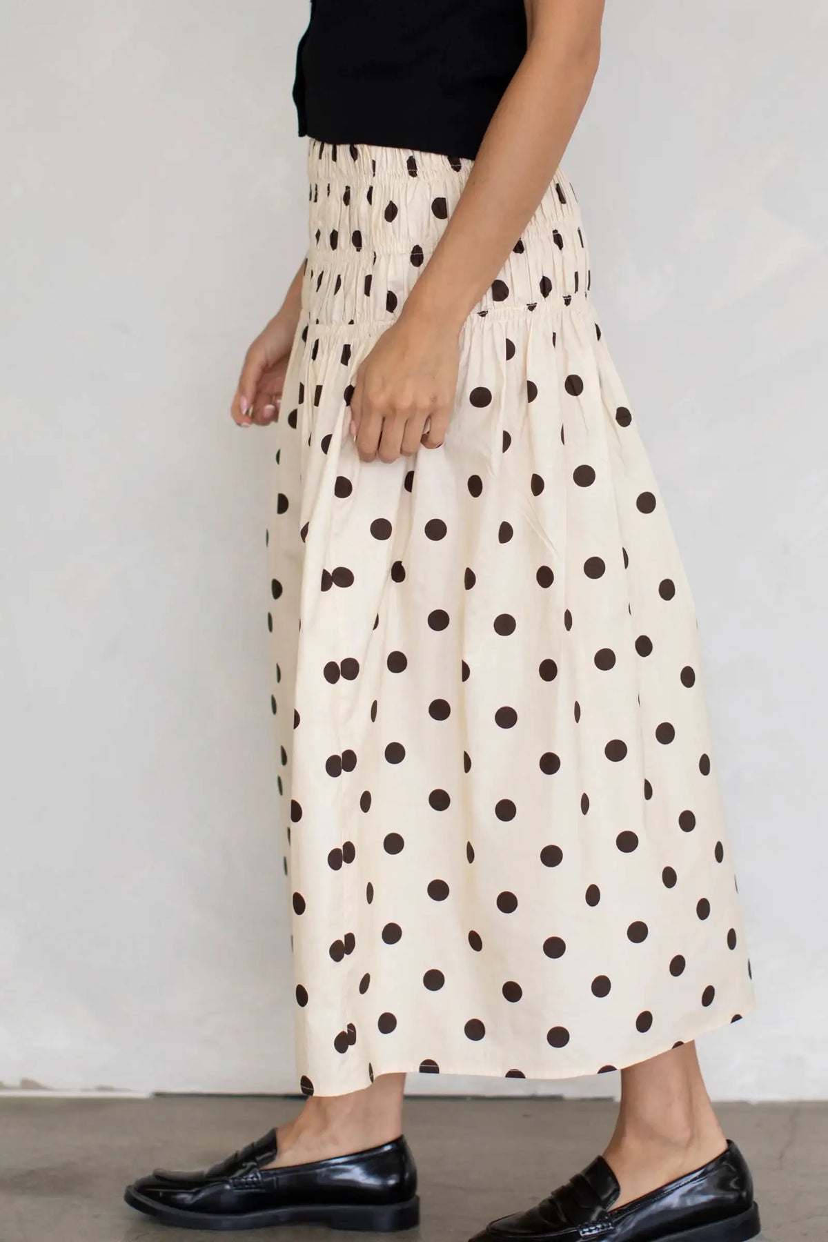 Long flowy chiffon skirt with elastic waist and printed design from Corporación Turística, shown in brown.