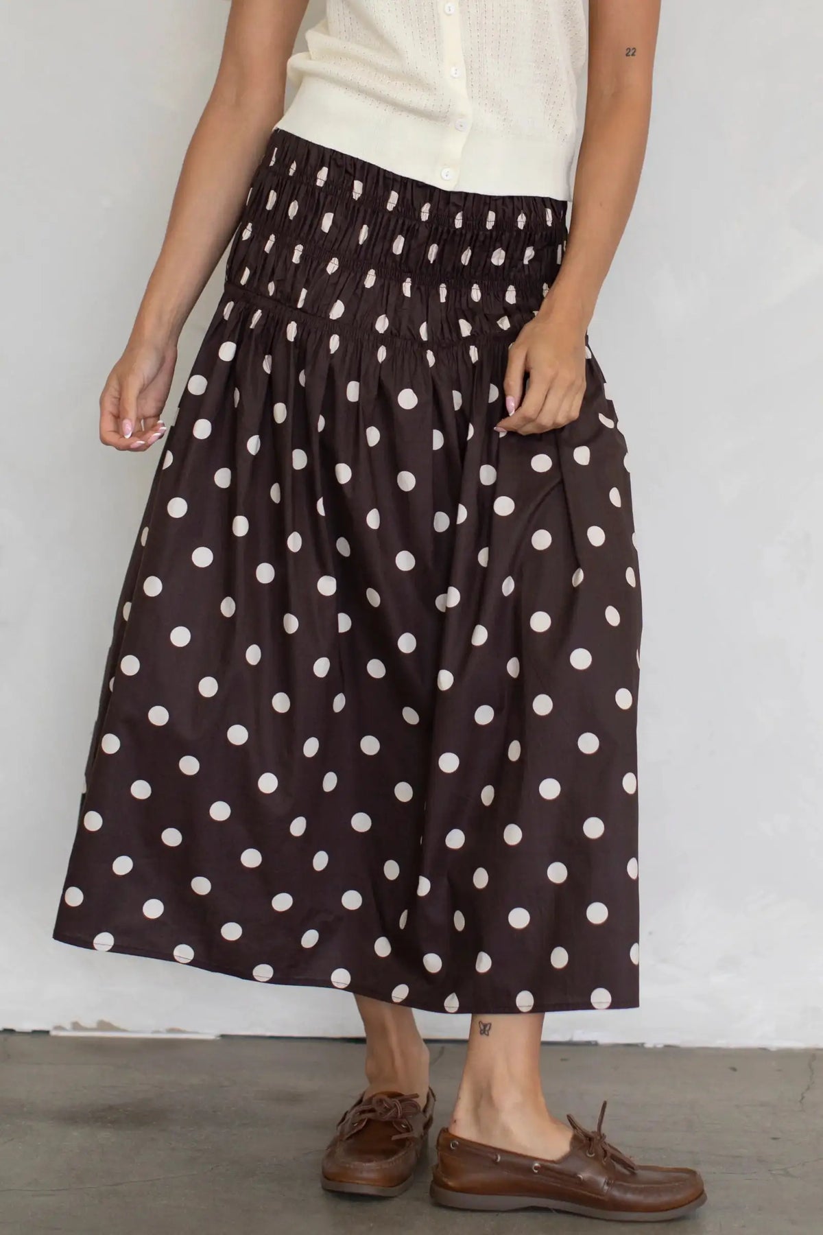 Long chiffon skirt with elastic waistband and floral print, by Corporación Turística, shown in brown fabric.