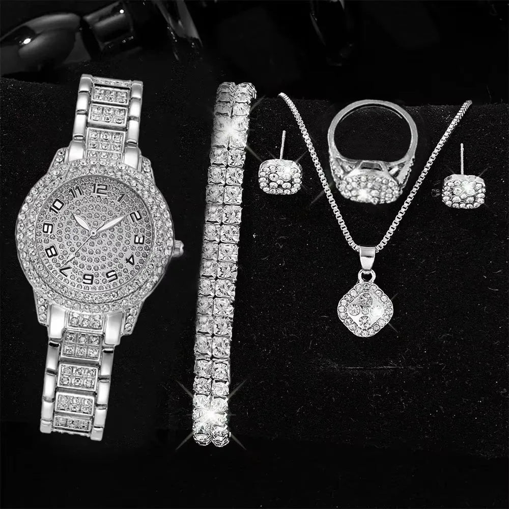 Silver steel Roman numeral bracelet watch with diamond accents, featuring a sleek strap and elegant design by Corporación Turística.