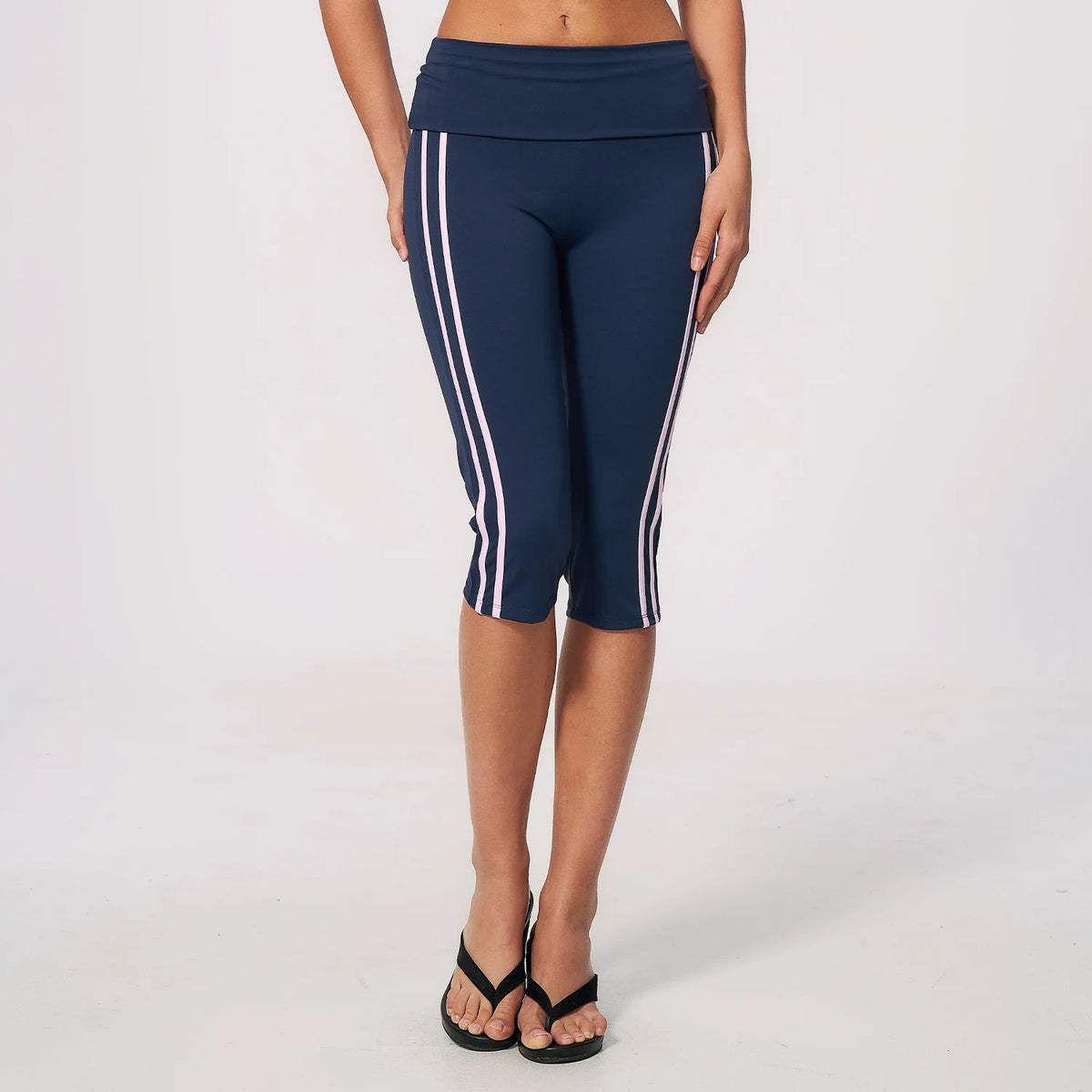 Moss green high-waist yoga capri leggings for women with a wide waistband, made by Corporación Turística, shown on a model.