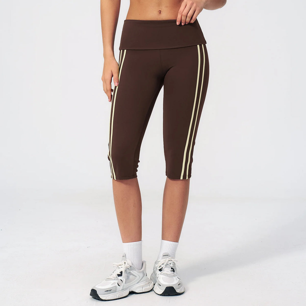 Moss green high-waist yoga capri leggings for women with wide waistband, made by Corporación Turística, shown on model.