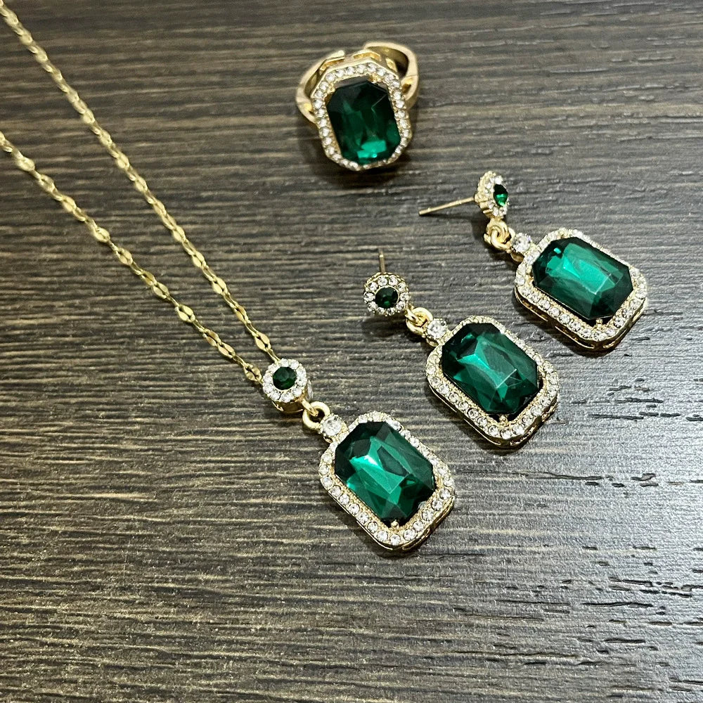 Set of jewelry for women including a necklace, earrings, and ring from Corporación Turística, featuring elegant gold-tone designs.