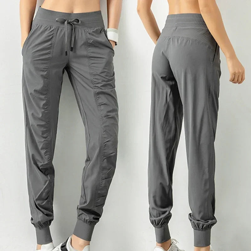 Navy blue women's sweatpants with drawstring, made of soft fabric, designed for running and casual wear, by Corporación Turística.