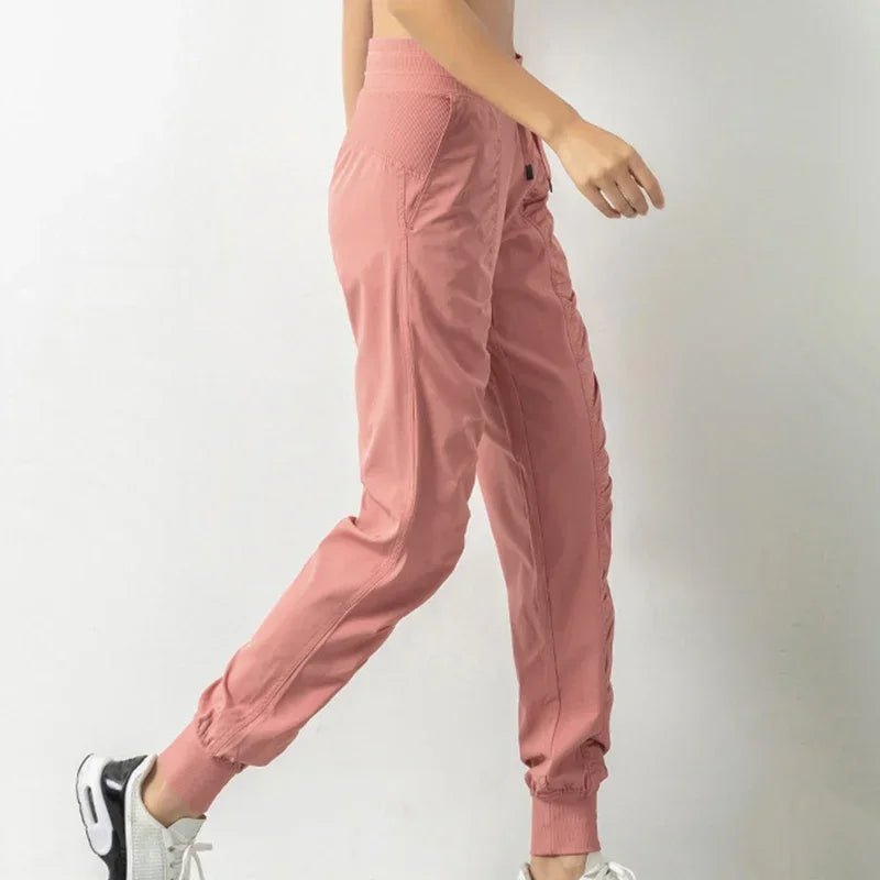 Navy blue women's athletic sweatpants with drawstring, made of soft fabric, designed for running and casual wear.