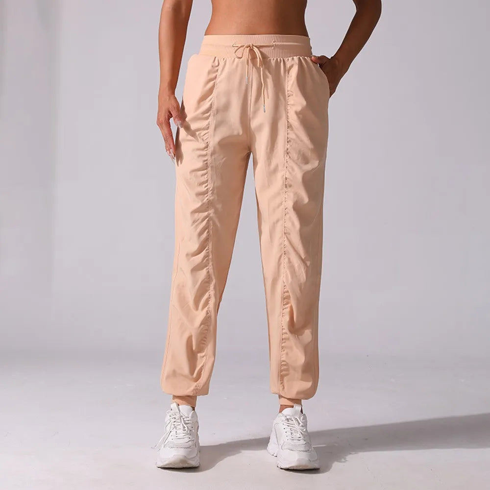 Navy blue women's jogger pants with drawstring from Corporación Turística, made of soft fabric, designed for running and casual wear.
