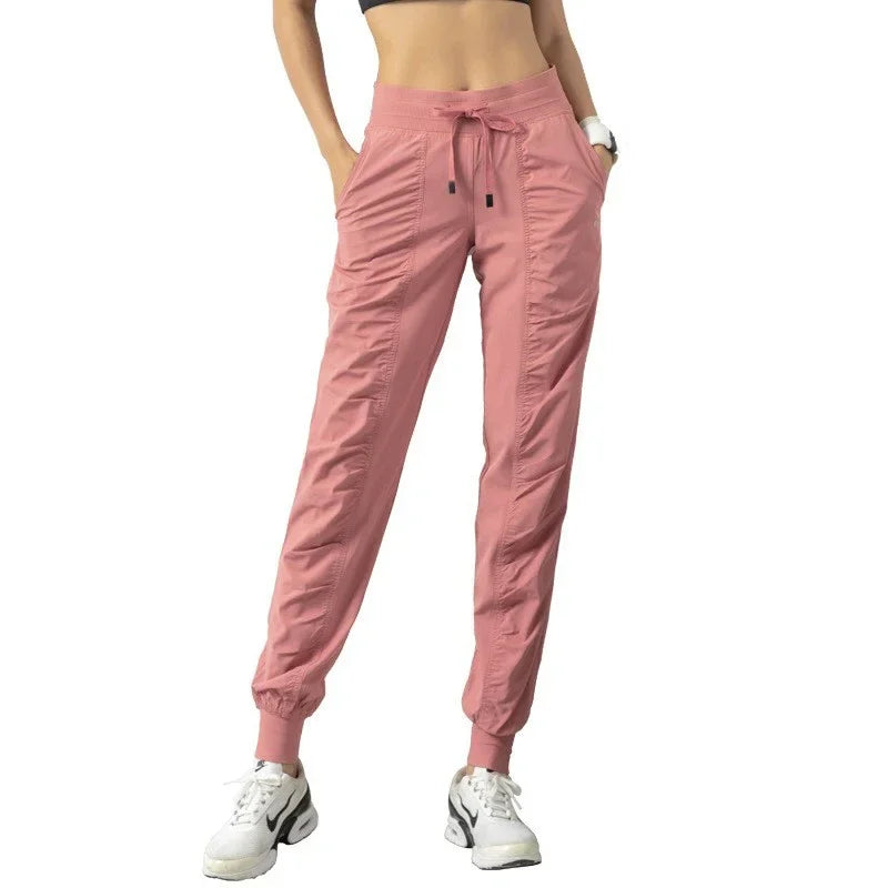 Navy blue women's sweatpants with drawstring waist, made of soft fabric, designed for running and casual wear by Corporación Turística.