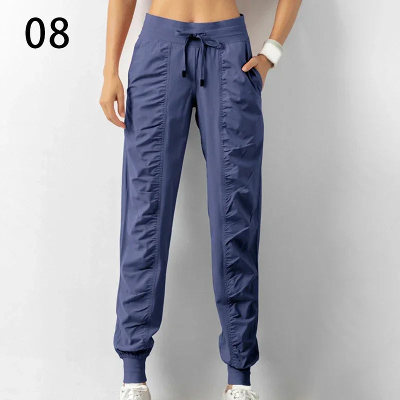 Navy blue women's jogger pants with drawstring, made of soft fabric, from Corporación Turística, ideal for running or casual wear.
