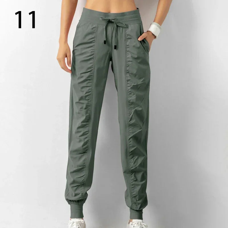 Navy blue women's sweatpants with drawstring from Corporación Turística, made of soft fabric, designed for running and casual wear.