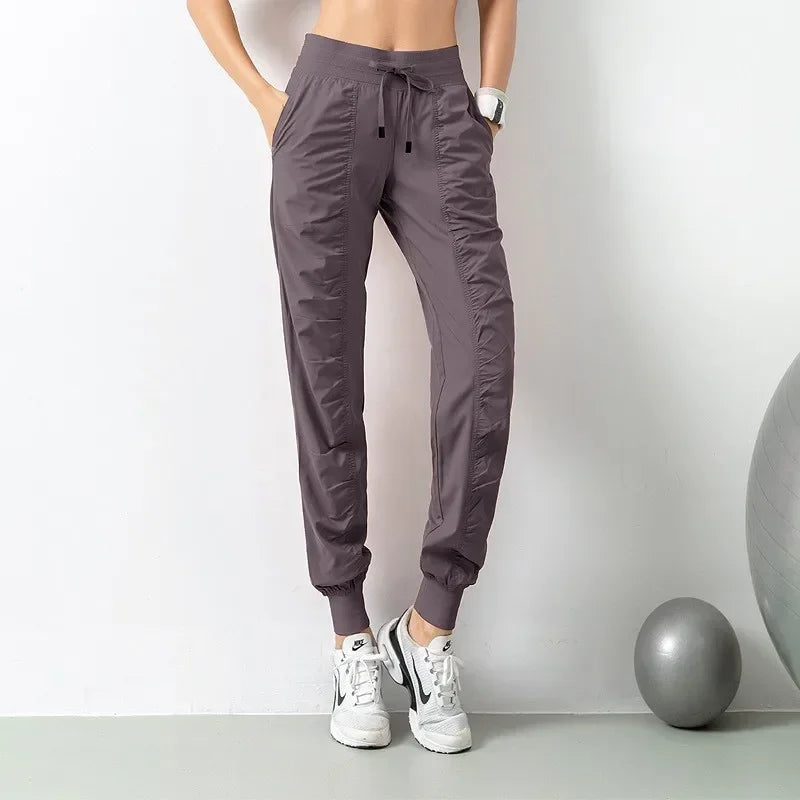 Navy blue women's sweatpants with drawstring, made of soft fabric, suitable for running and casual wear by Corporación Turística.