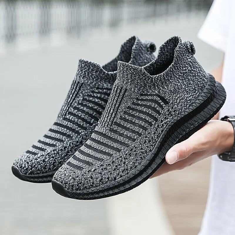 Black breathable men's sneakers from Corporación Turística, featuring comfortable design and sporty style.