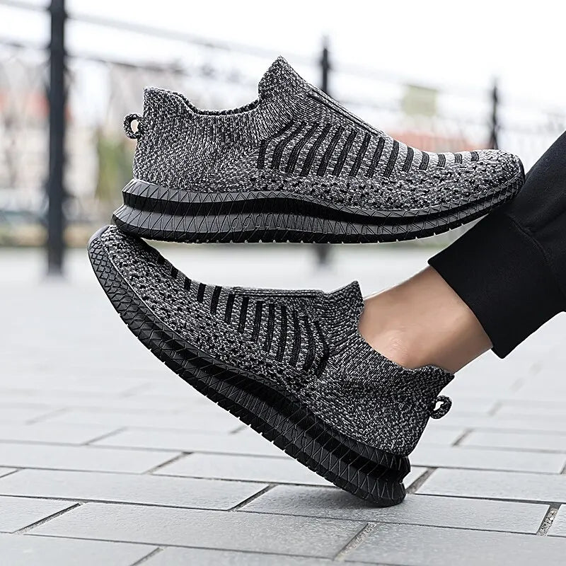 Black men's breathable sneakers from Corporación Turística, showing the lightweight, comfortable design and casual style.
