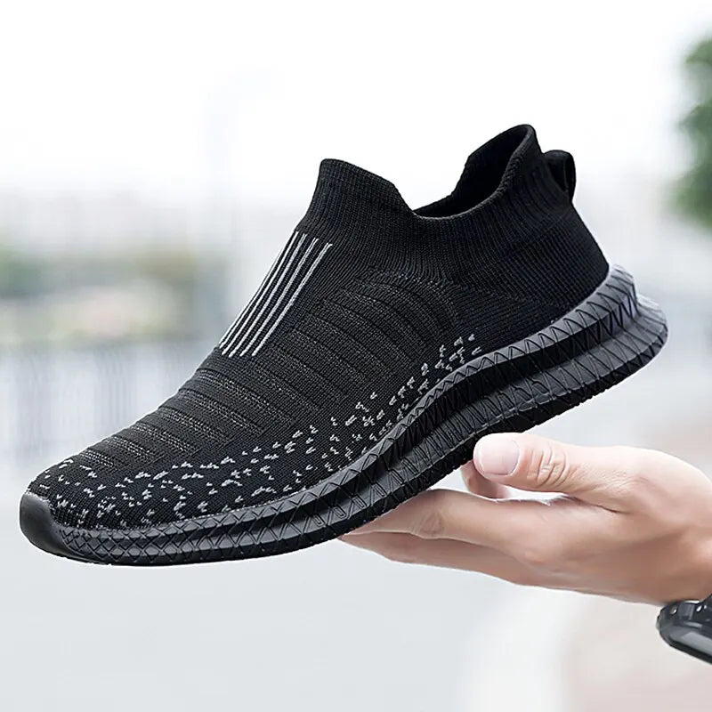 Black men's breathable sneakers from Corporación Turística, featuring lightweight design and comfortable fit.