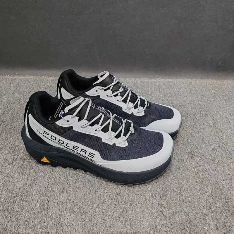 Black professional running shoes for men and women by Corporación Turística, featuring breathable mesh and cushioned soles.