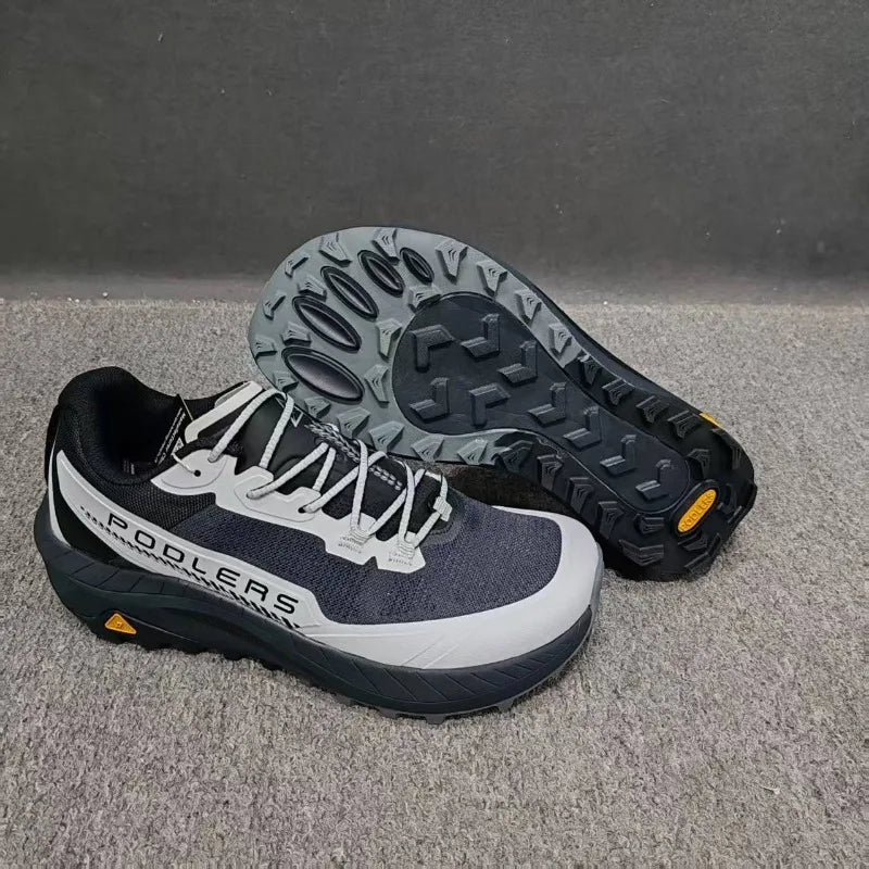 Black professional running shoes for men and women by Corporación Turística, featuring breathable mesh and cushioned soles.