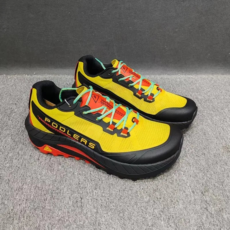 Black professional running shoes for men and women by Corporación Turística, featuring breathable mesh and cushioned soles.