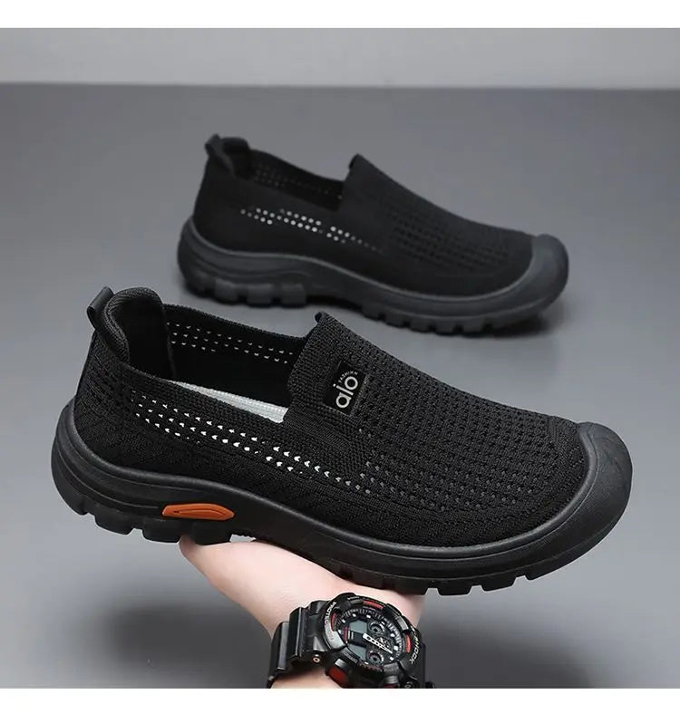 Black men's summer breathable mesh shoes by Corporación Turística, lightweight and comfortable for warm weather.