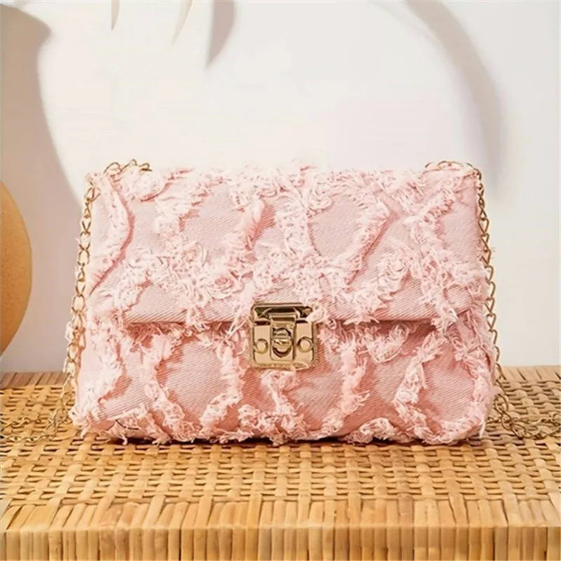 Black crossbody handbag with stylish design, ideal for casual wear and pairing with denim jeans.