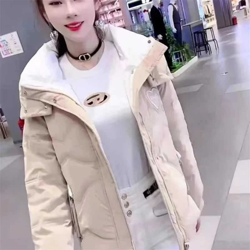 Black women's 2025 winter parka jacket by Corporación Turística, featuring a warm, stylish design with a hood and zipper closure.