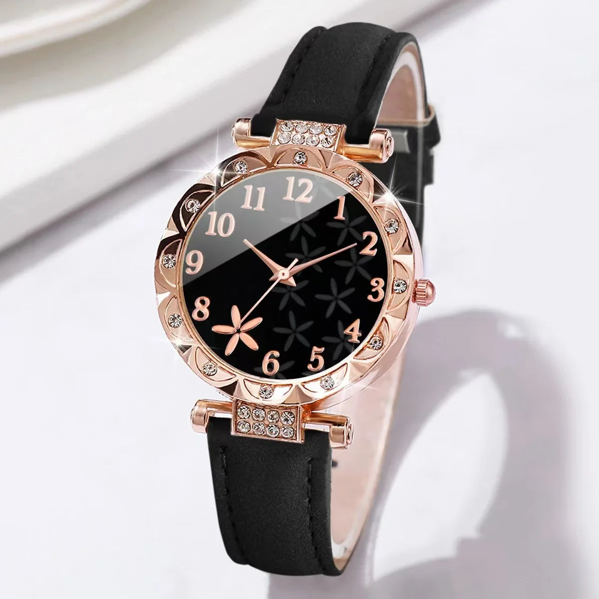 Two fashionable black quartz wristwatches with diamond accents from Corporación Turística, stylish and elegant for everyday wear.