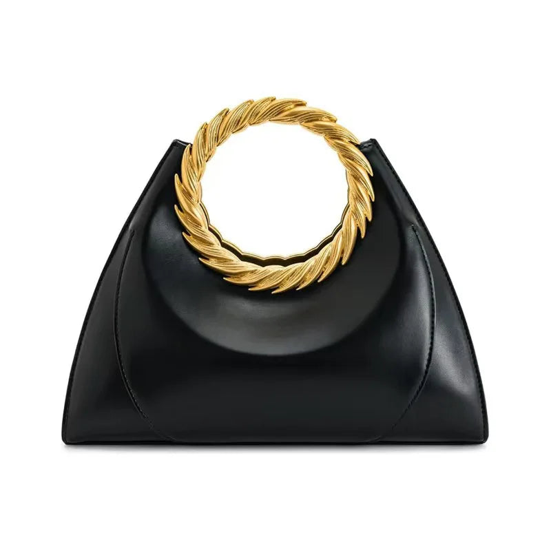 Luxury women's black hand clutch bag from Nuevo Diseño 2026 collection by Corporación Turística, featuring elegant design and gold accents.