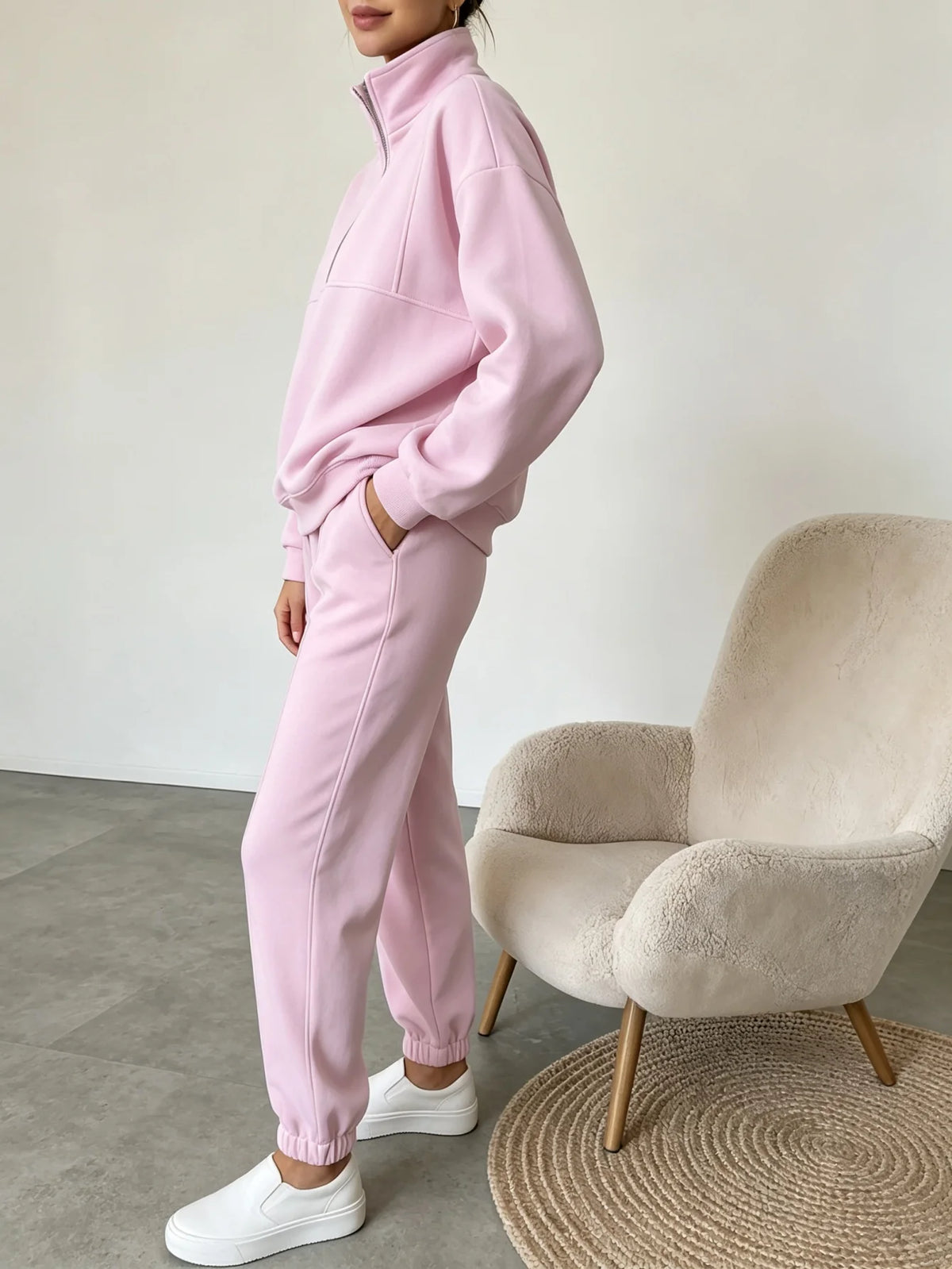 Black sweatshirt and pants set by Corporación Turística featuring half-zip sweatshirt and matching comfortable joggers.