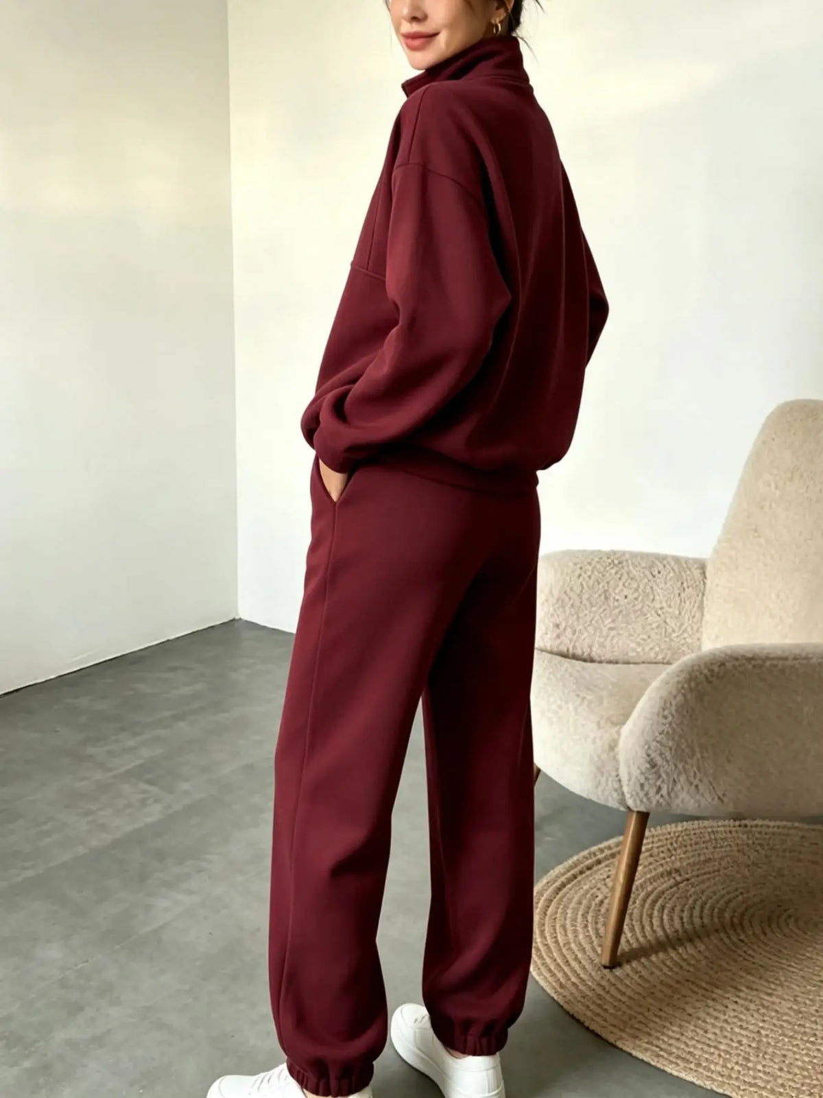 Black sweatshirt and pants set by Corporación Turística with half-zip sweatshirt and matching trousers, casual and comfortable.
