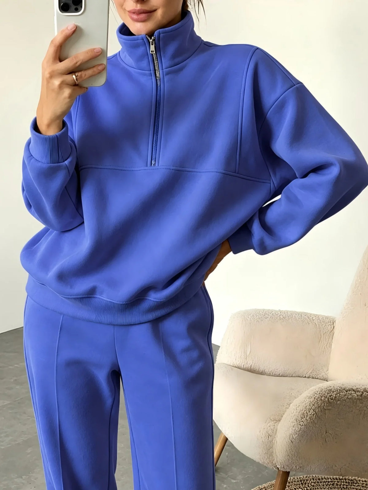 Black sweatshirt set with half-zip and matching pants from Corporación Turística, casual and comfortable for everyday wear.