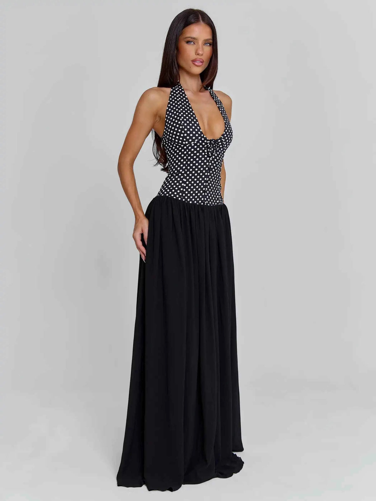 Elegant black sleeveless evening dress with halter neckline by Corporación Turística, suitable for formal parties and events.