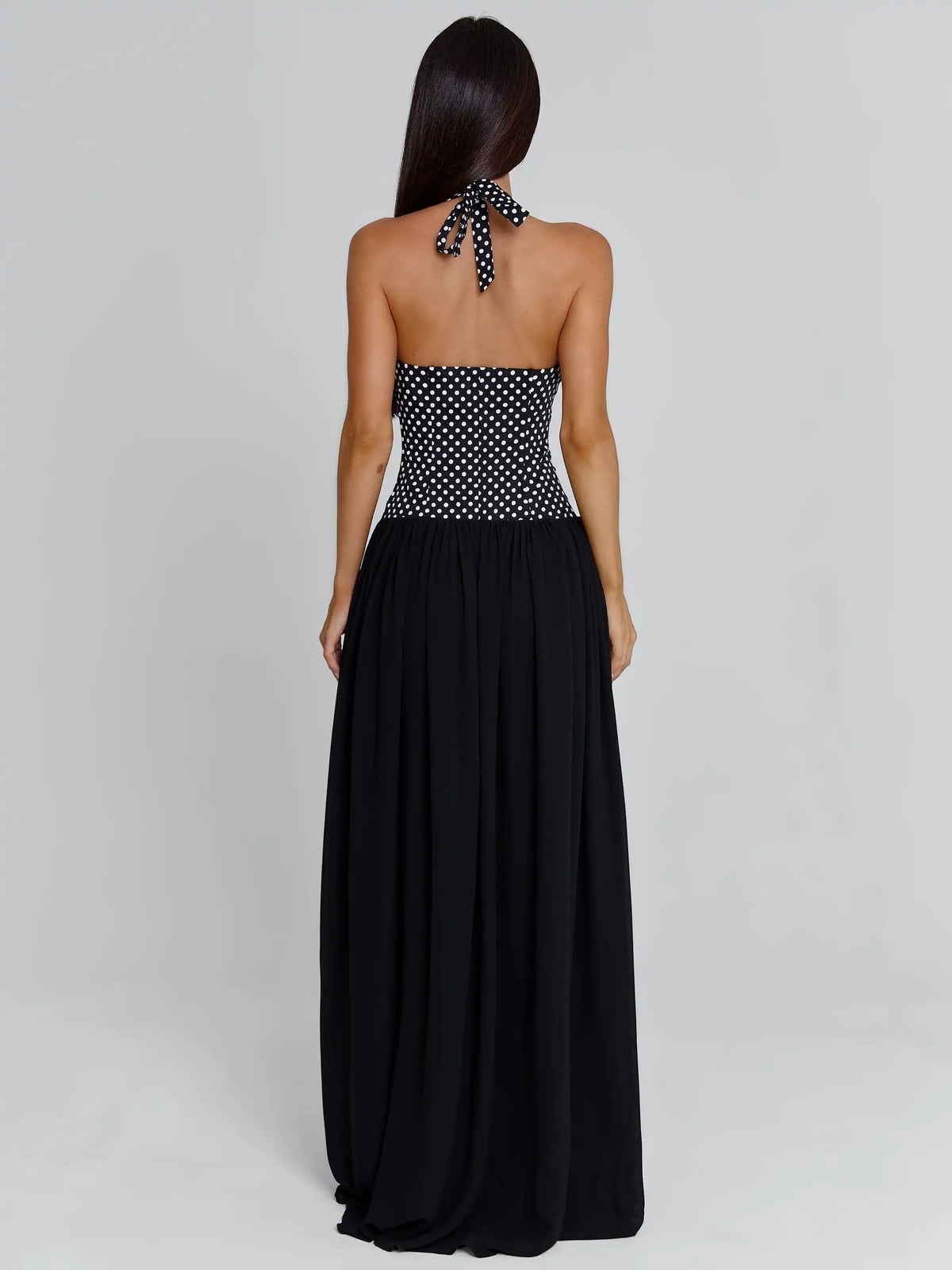 Elegant sleeveless black evening dress with a halter neckline by Corporación Turística, suitable for formal occasions.
