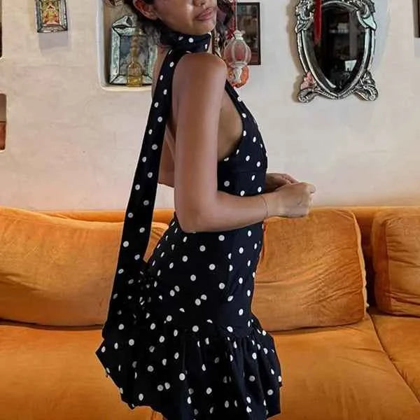 Summer women's dress with V-neck and floral print by Corporación Turística, shown in black fabric.