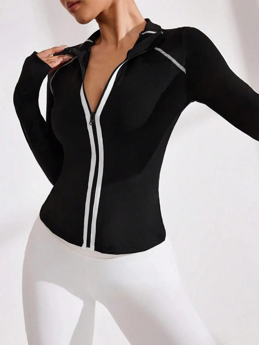 Black women's yoga jacket with zipper and high collar from Corporación Turística, shown on a model.