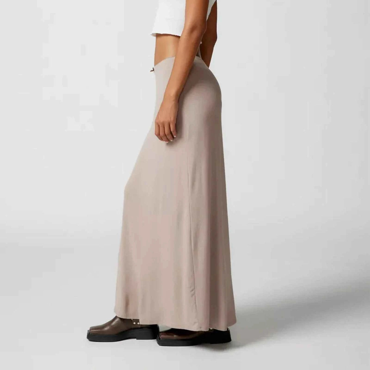 Black casual long skirts for women, straight fit, by Corporación Turística, displayed on a model against a neutral background.