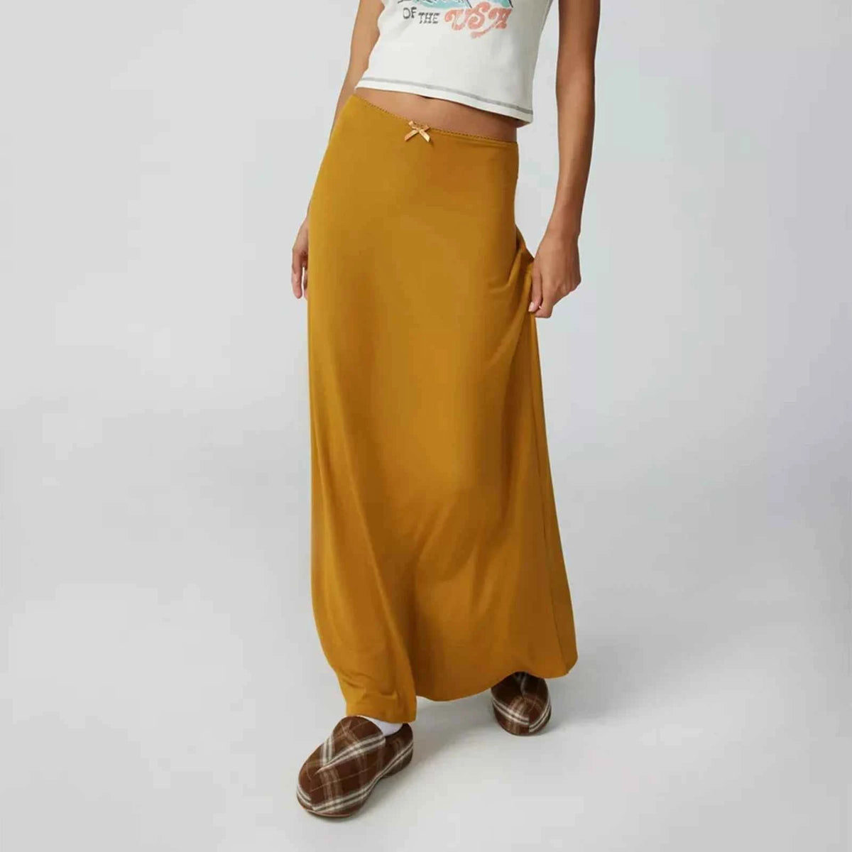 Long casual black women's skirts with straight fit, designed by Corporación Turística, shown on a model.