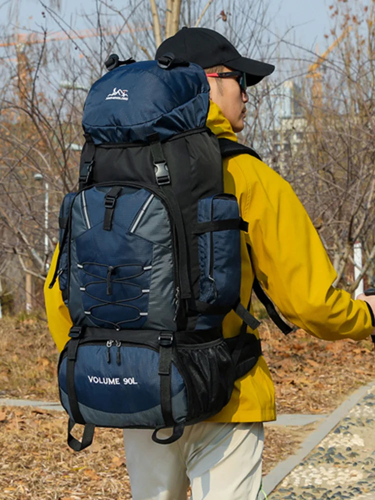 Large 90L hiking and camping backpack by Corporación Turística, with adjustable straps and multiple compartments for outdoor adventures.