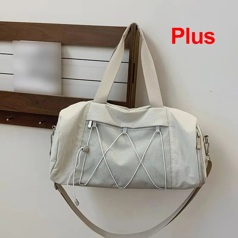 Black gym and travel bag for women and men by Corporación Turística, with adjustable shoulder strap and multiple compartments.