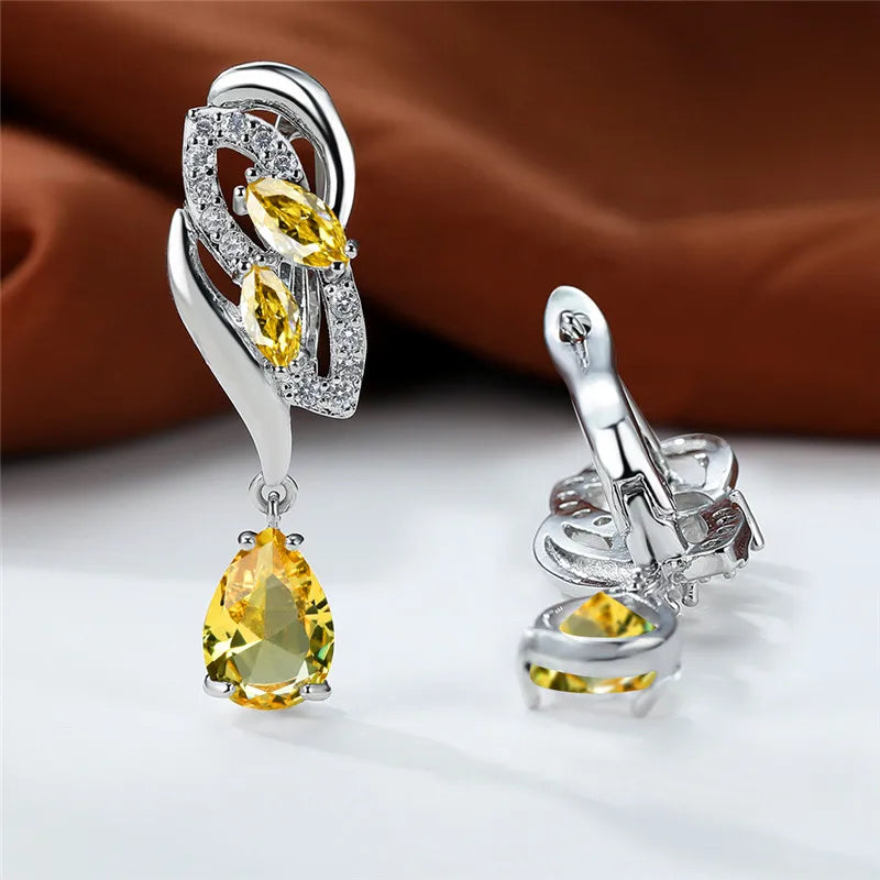 Luxury blue rainbow stone earrings for women featuring elegant gold accents, designed by Corporación Turística.