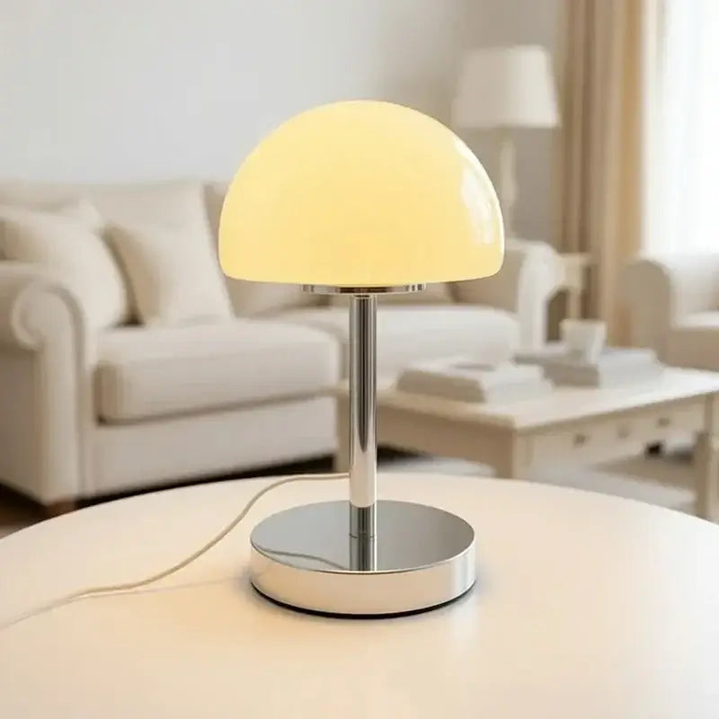 Crystal table lamp with mushroom-shaped glass shade and base, featuring vibrant orange color and elegant design.