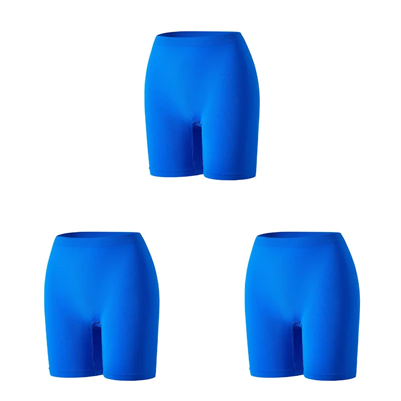 Set of three women's safety shorts in bright orange by Corporación Turística, shown laid flat for display.