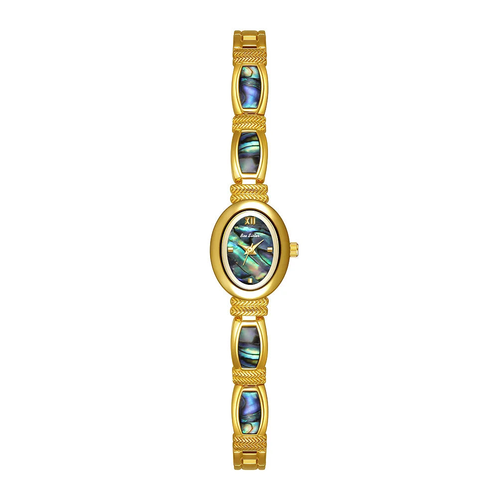 Gold oval-faced women's wristwatch by Corporación Turística with elegant design and a matching jewelry box.
