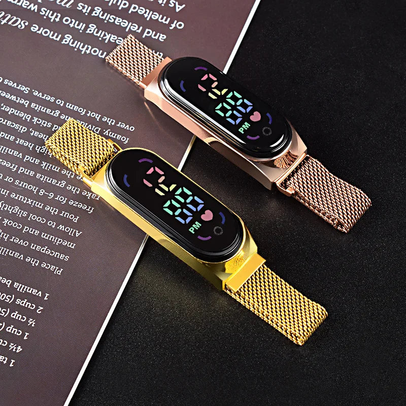 Gold LED electronic watch with magnetic bracelet and alloy band by Corporación Turística, showcasing the sleek design and digital display.