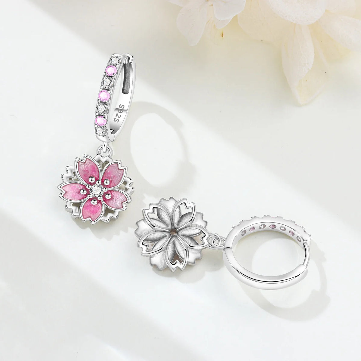 Sterling silver earrings with unique F-shaped design by Corporación Turística, showcasing intricate craftsmanship and elegant style.