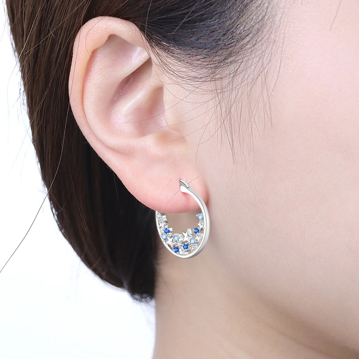 Sterling silver Orstarry earrings with blue cubic zirconia stones, featuring a delicate dangle design and shiny finish.