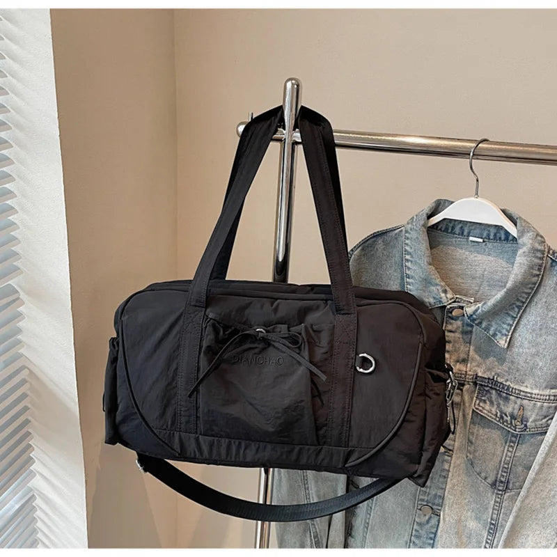 Large gym bag for yoga, travel, and hiking by Corporación Turística, pink fabric with multiple compartments and sturdy handles.
