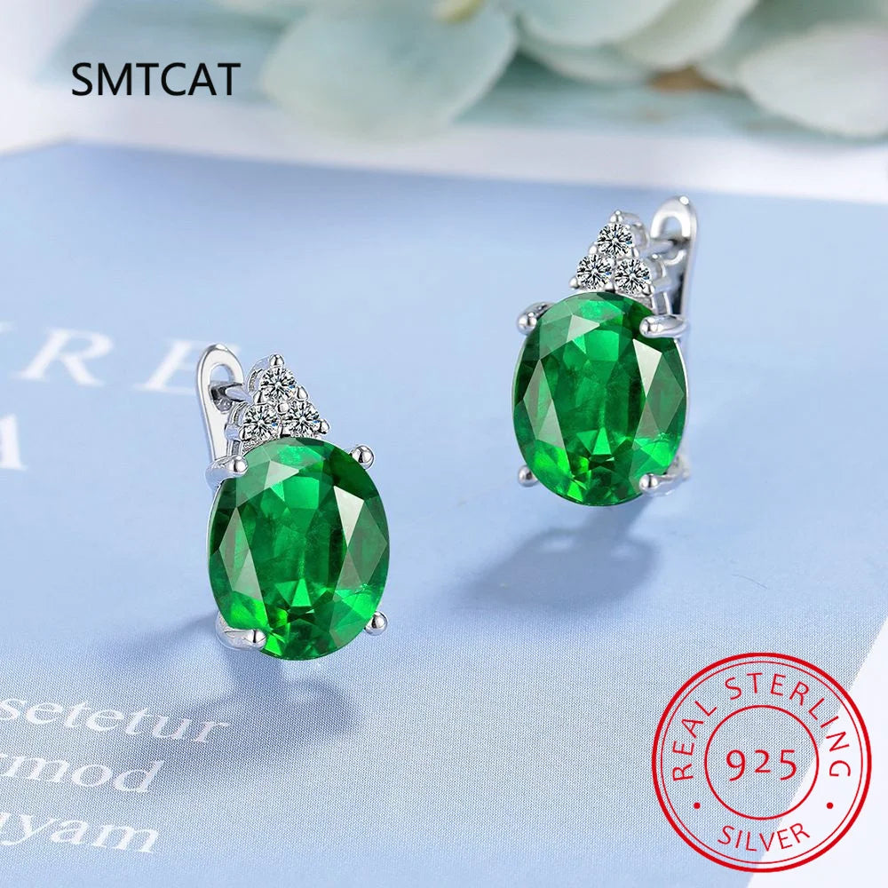 Silver 925 hoop earrings with blue sapphire accents, featuring elegant and polished jewelry design.