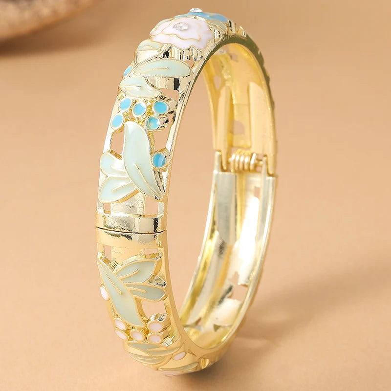 Pink floral enamel bracelet for women featuring rose flower designs, crafted by Corporación Turística.