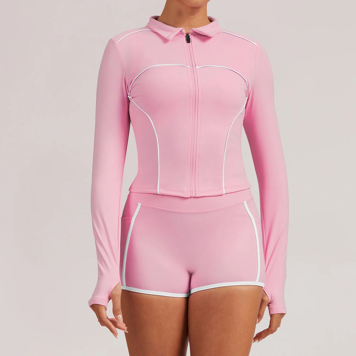 Pink women's yoga jacket for training and gym, by Corporación Turística, shown on a mannequin in a fitness setting.