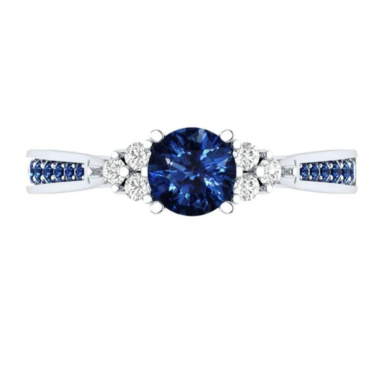 Sterling silver S925 ring with a genuine blue sapphire, showcasing intricate craftsmanship and a polished finish.