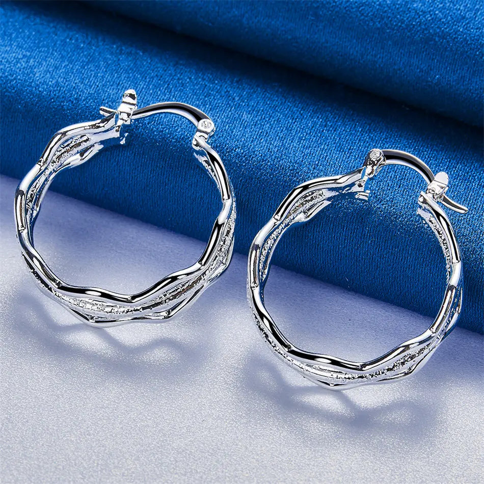 Sterling silver pendants with wave design by Corporación Turística, featuring elegant, flowing silver waves for stylish jewelry.